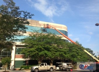 Stained commercial building facade before pressure washing
