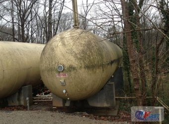 Dirty industrial propane tank covered in algae and grime before pressure washing