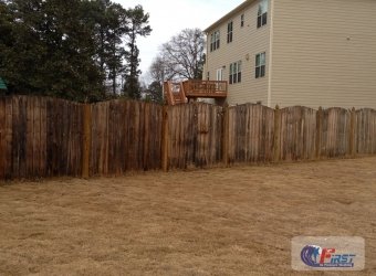 Weathered wooden fence before pressure washing
