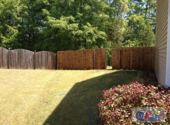 Weathered wooden fence before pressure washing