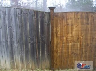 Weathered wooden fence before pressure washing