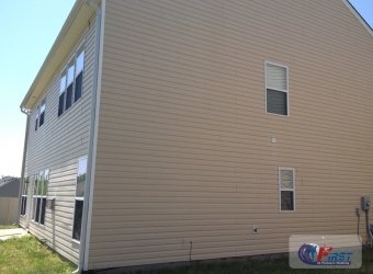 Clean vinyl house siding after pressure washing