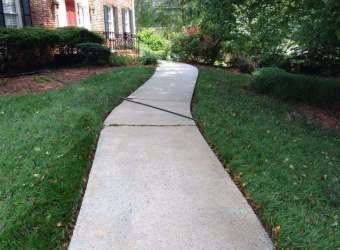 Clean concrete walkway after pressure washing
