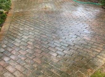 Dirty brick patio before pressure washing