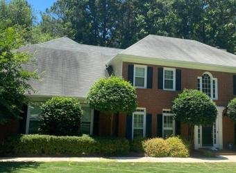 Stained shingle roof before roof cleaning