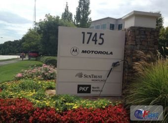 Commercial property entrance sign with landscaping