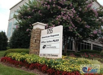 Office building entrance sign with landscaped grounds